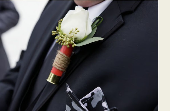 White rose boutonniere with greenery and a wrapped stem